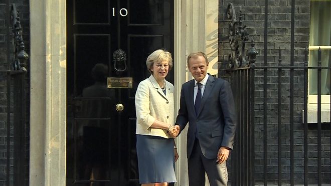 Awkward: When Theresa May met Donald Tusk, the handshake went on a long time - probably because she was trying to think of something worthwhile to say.