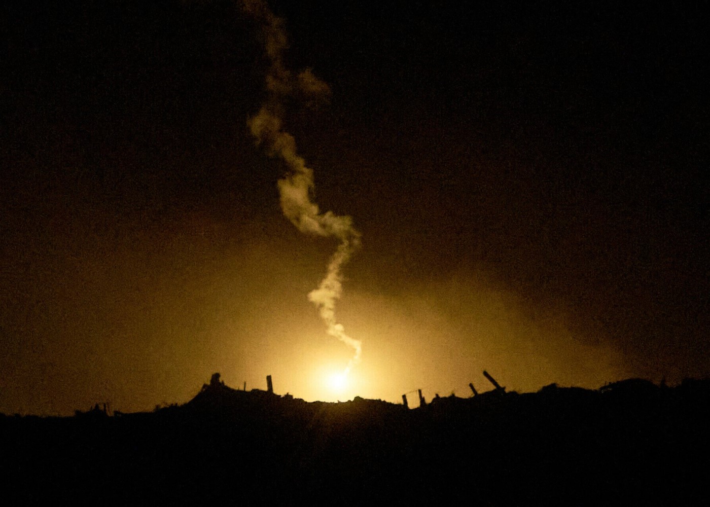 Israeli airstrikes hitting Gaza during a fragile ceasefire, with smoke rising above destroyed buildings.